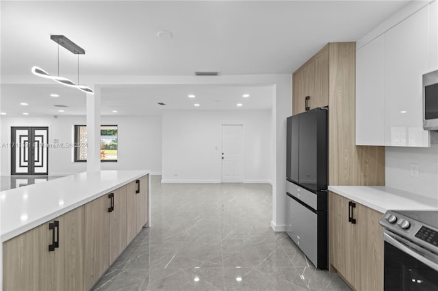 kitchen featuring light brown cabinetry, white cabinetry, pendant lighting, and stainless steel appliances