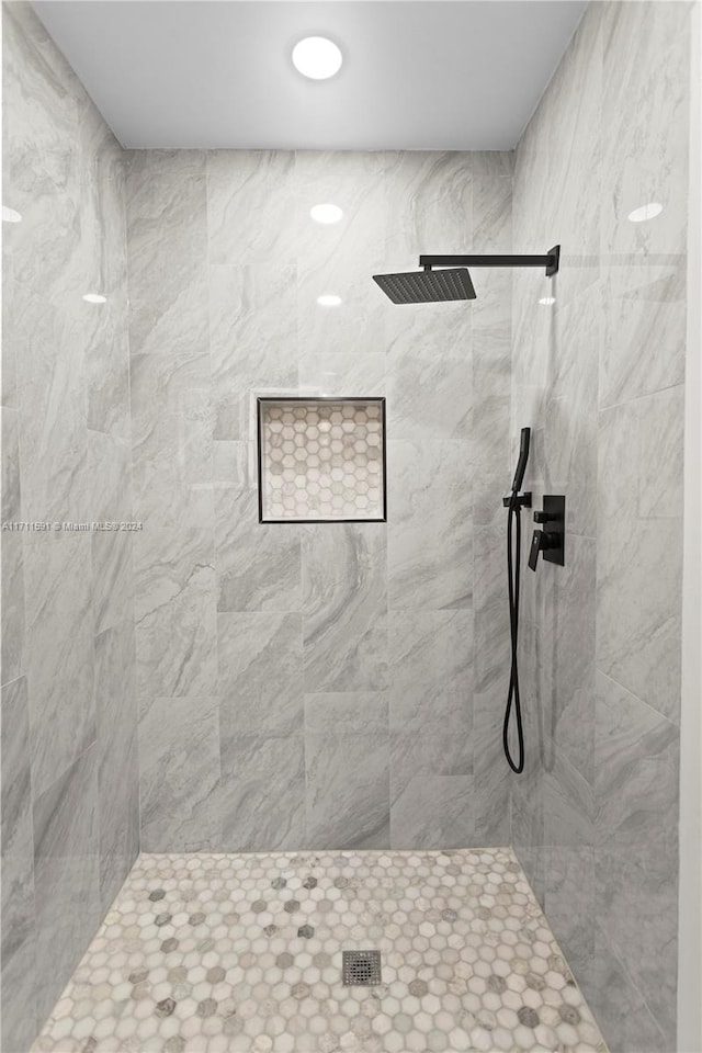 bathroom with tiled shower