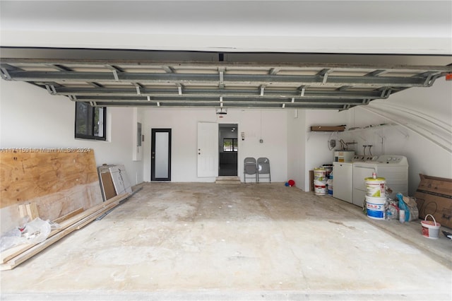 garage featuring washing machine and dryer and electric panel