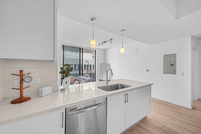 kitchen featuring light wood-type flooring, white cabinets, sink, pendant lighting, and dishwasher