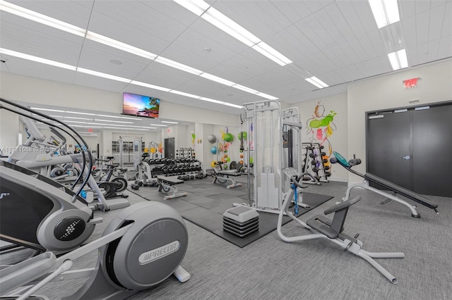 workout area featuring a paneled ceiling