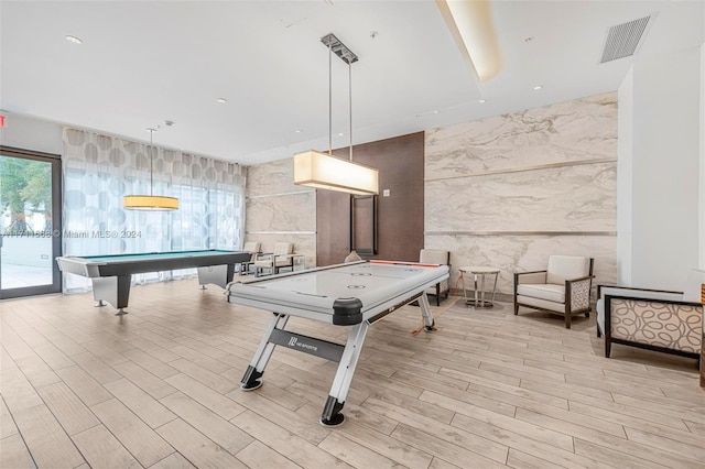 playroom featuring light hardwood / wood-style floors, tile walls, and pool table