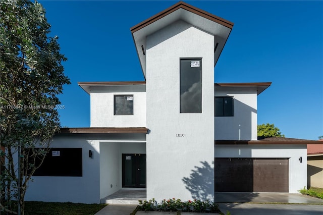 contemporary house featuring an attached garage and stucco siding