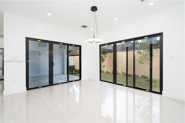 spare room with baseboards, visible vents, and recessed lighting