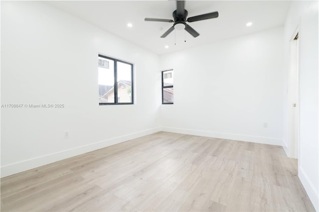 unfurnished room with baseboards, recessed lighting, and light wood-style floors