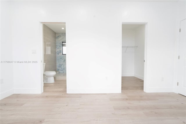 interior space with wood finished floors and baseboards