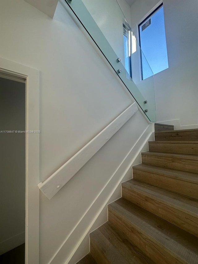 staircase with wood finished floors