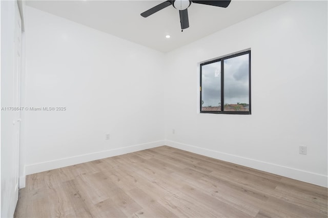 empty room with ceiling fan, recessed lighting, light wood-style flooring, and baseboards