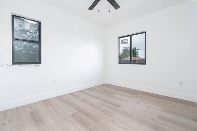 unfurnished room with light wood-style flooring, baseboards, and a ceiling fan