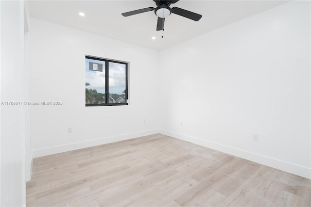 spare room featuring a ceiling fan, recessed lighting, light wood-style flooring, and baseboards