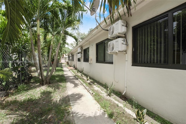 view of property exterior with stucco siding and ac unit
