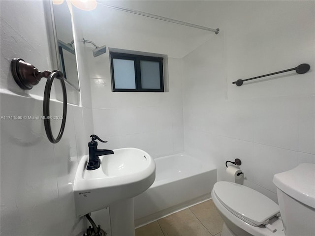 bathroom with tile patterned floors, toilet, and tile walls