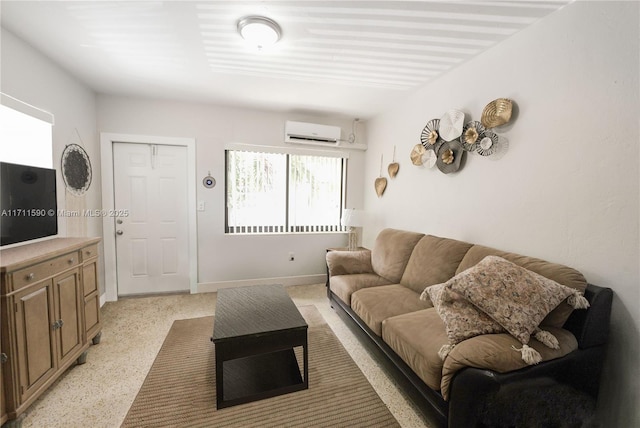 living area with an AC wall unit and baseboards