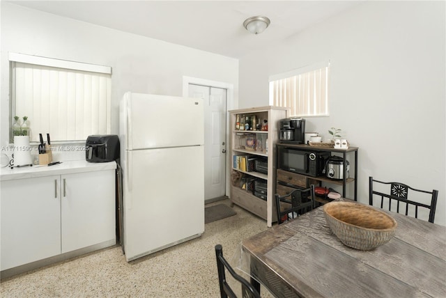 dining area with light speckled floor