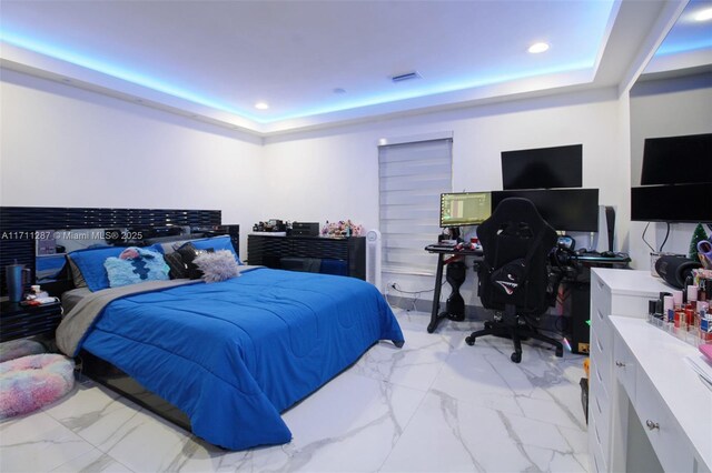 bedroom with a tray ceiling