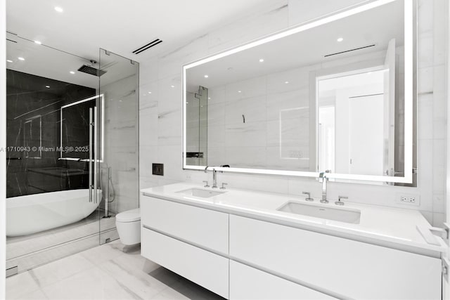 full bathroom featuring vanity, independent shower and bath, tile walls, and toilet