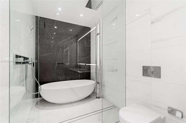 bathroom featuring tile patterned flooring, shower with separate bathtub, toilet, and tile walls