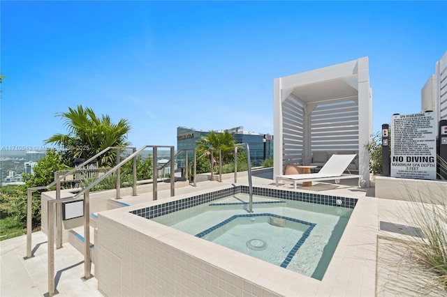 view of swimming pool featuring a hot tub