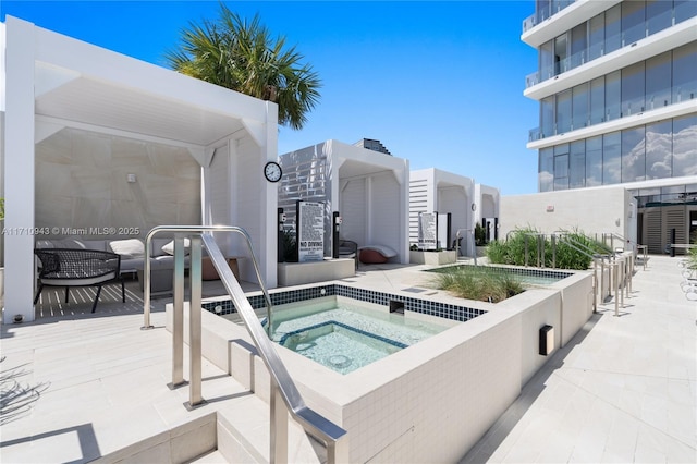 view of swimming pool featuring a community hot tub and a patio