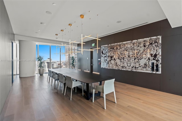 dining room with floor to ceiling windows and hardwood / wood-style floors