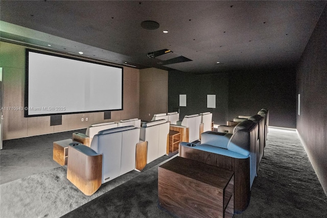 home theater room with dark colored carpet