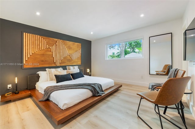 bedroom with hardwood / wood-style flooring