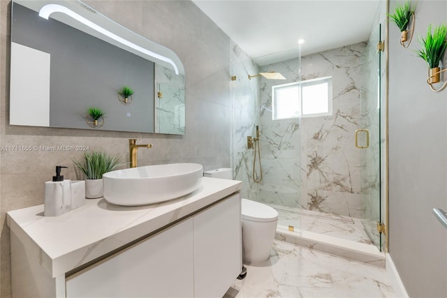 bathroom with vanity, toilet, and a shower with door