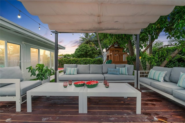 patio terrace at dusk featuring an outdoor living space