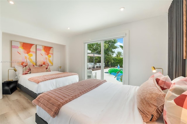 bedroom with access to exterior and light hardwood / wood-style floors