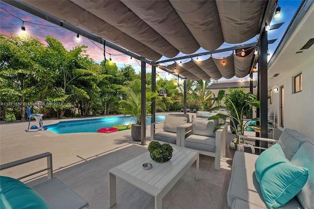 pool at dusk with a patio area and an outdoor living space