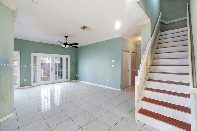 staircase with tile patterned floors, ceiling fan, french doors, and ornamental molding