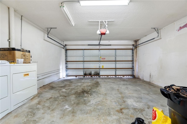 garage with separate washer and dryer and a garage door opener