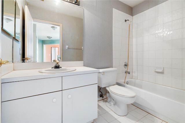 full bathroom featuring tile patterned floors, vanity, toilet, and tiled shower / bath