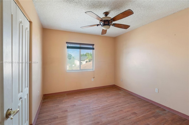 unfurnished bedroom featuring a textured ceiling, light wood-type flooring, and ceiling fan