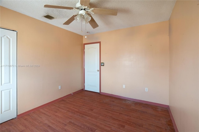 empty room featuring a textured ceiling, hardwood / wood-style flooring, and ceiling fan