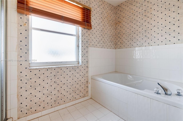 bathroom featuring tile patterned floors and a relaxing tiled tub