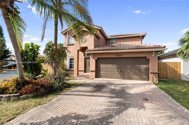 mediterranean / spanish home featuring a garage