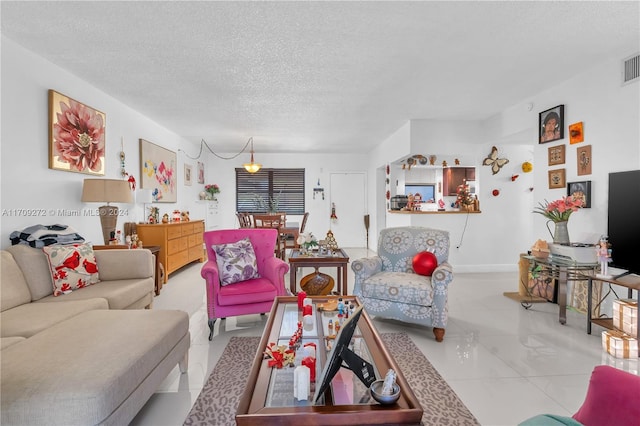 living room featuring light tile patterned floors and a textured ceiling