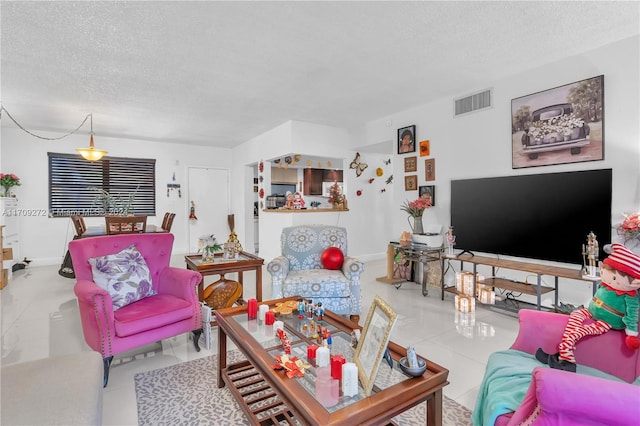 tiled living room featuring a textured ceiling