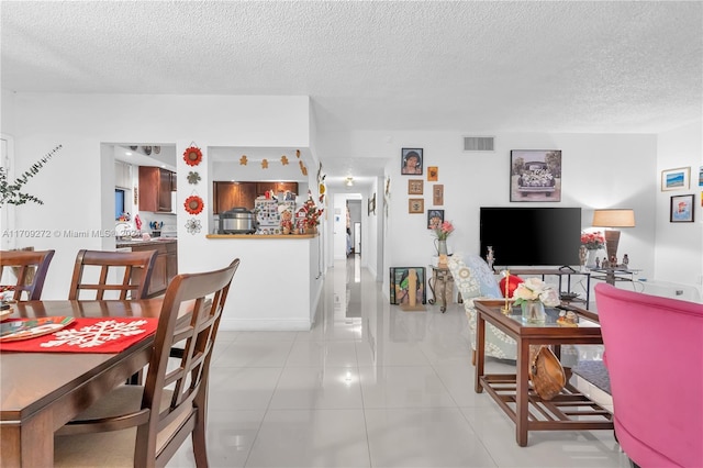 tiled living room with a textured ceiling