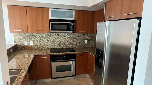 kitchen with stainless steel appliances, tasteful backsplash, and stone countertops