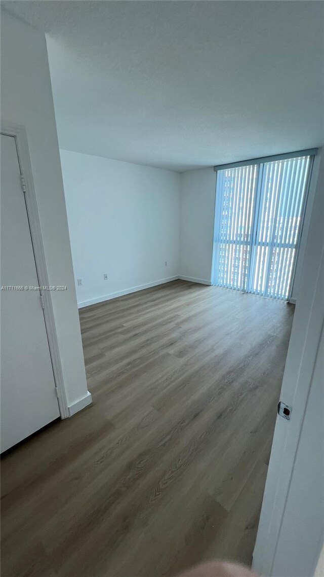 unfurnished room featuring wood-type flooring