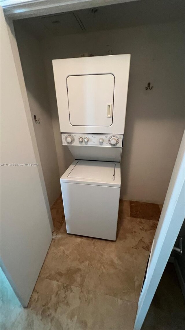 laundry room with stacked washer / drying machine