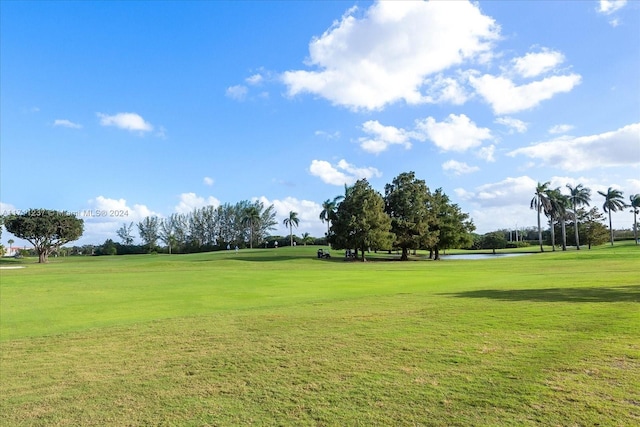 view of property's community featuring a yard and a water view