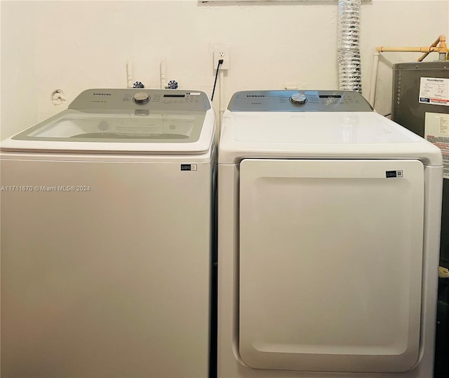 clothes washing area with separate washer and dryer