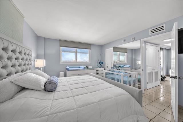 bedroom with light tile patterned floors