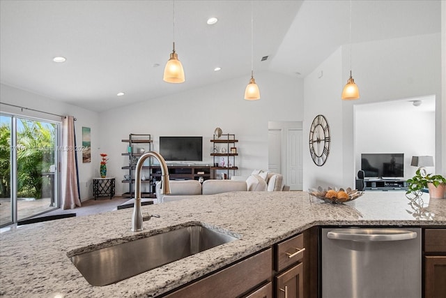 kitchen featuring dishwasher, pendant lighting, lofted ceiling, and sink