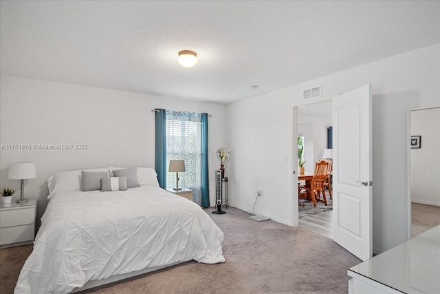 carpeted bedroom with a textured ceiling