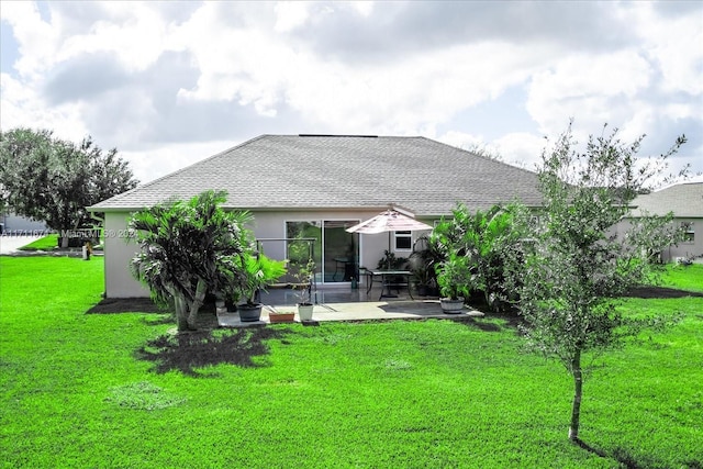 back of property with a yard and a patio area