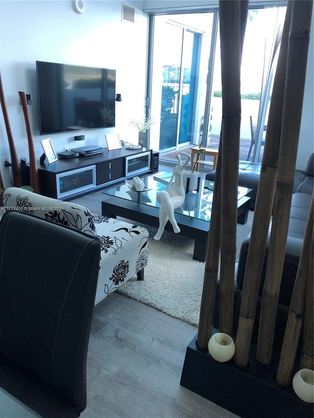 living room with a water view and light wood-type flooring